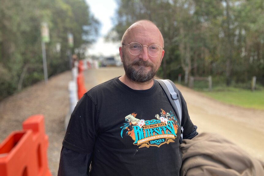 A bald man with glasses in a Bluesfest shirt