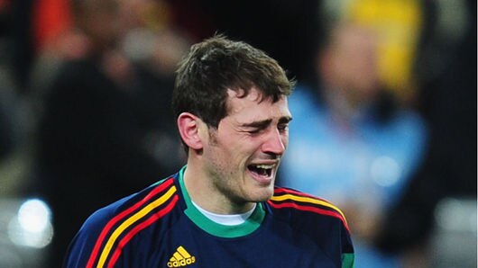 Tears of joy: Spain captain Iker Casillas sinks to his knees at full-time.