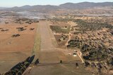 Drone photo of the Tenterfield aerodrome showing runway and two hangers 