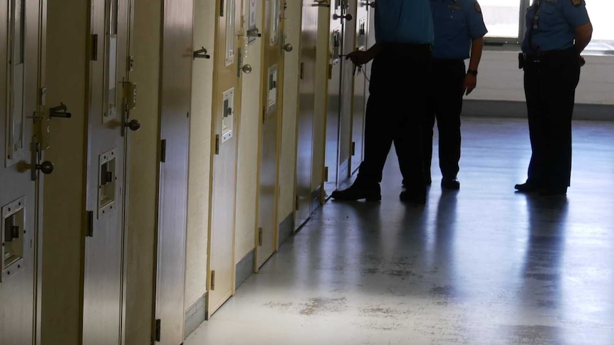 Corridor at Greenough Prison with three unidentified staff
