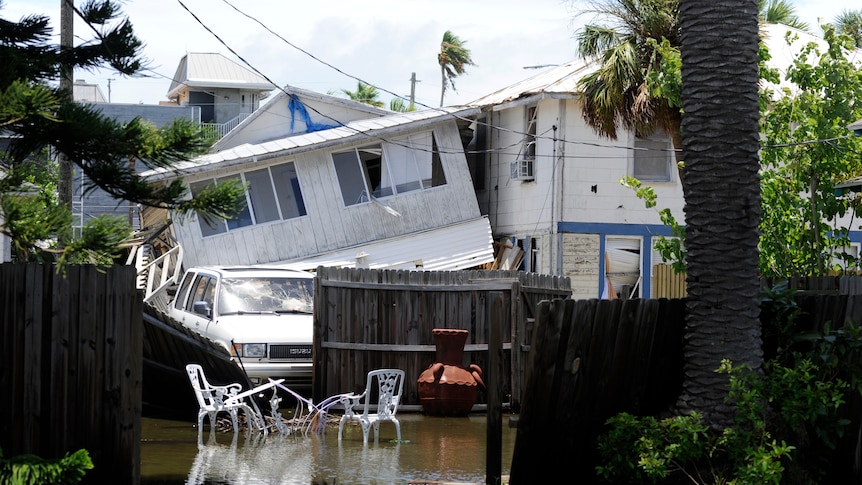 Structural damage is seen on a street in Pass-A-Grille Beach, damaged on Sunday night by what residents describe as a tornado.