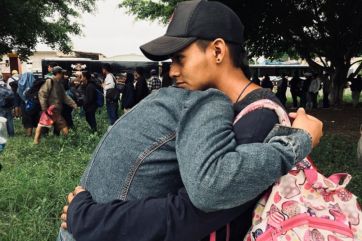 A Salvadoran couple travelling to the United States hug.