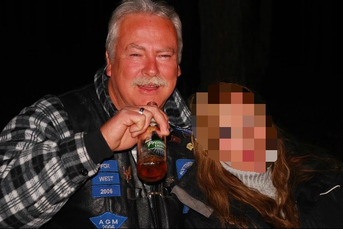 a former nsw senior prison guard wayne astill holding a bottle of beer with a person whose face is pixelated for legal reason