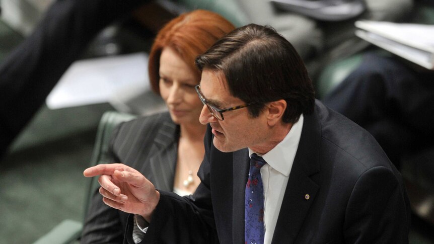 Gillard listens to climate change minister Greg Combet during question time