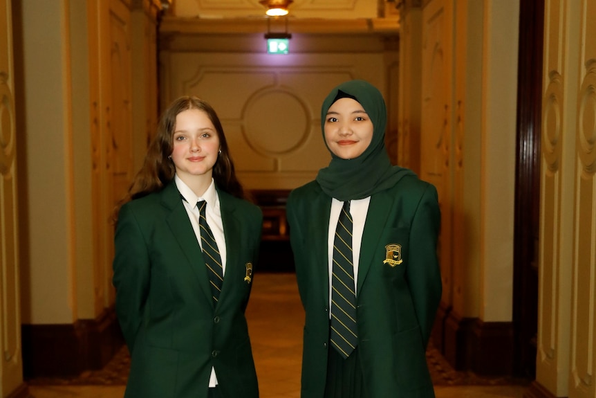 two school girls standing side by side
