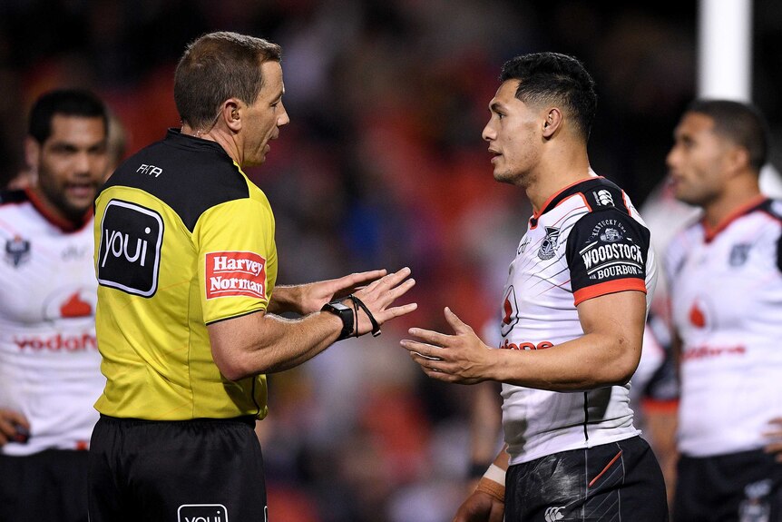 NRL referee Ben Cummins speaks to Warriors captain Roger Tuivasa-Sheck during a rugby league game.