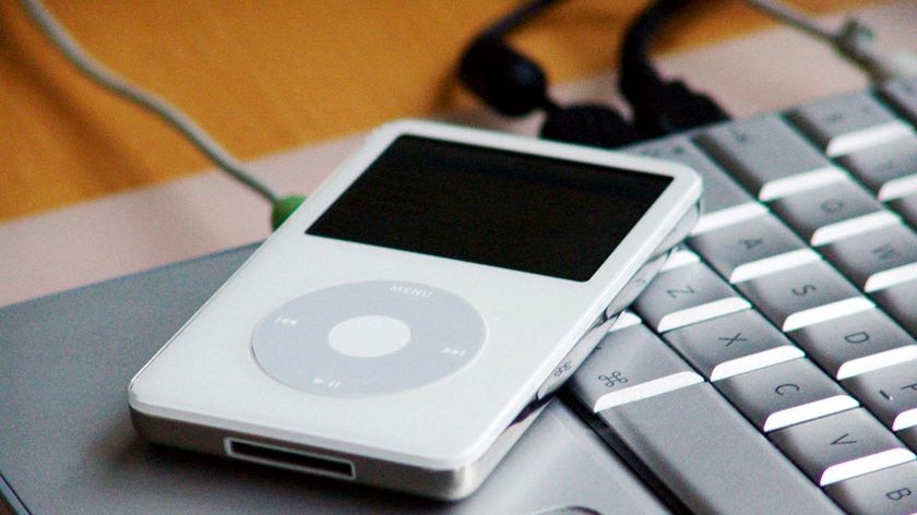 An Apple iPod sits on a laptop