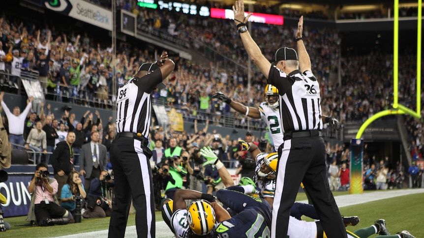 Seattle's Golden Tate (81) is given a touchdown despite two referees disagreeing on the call.