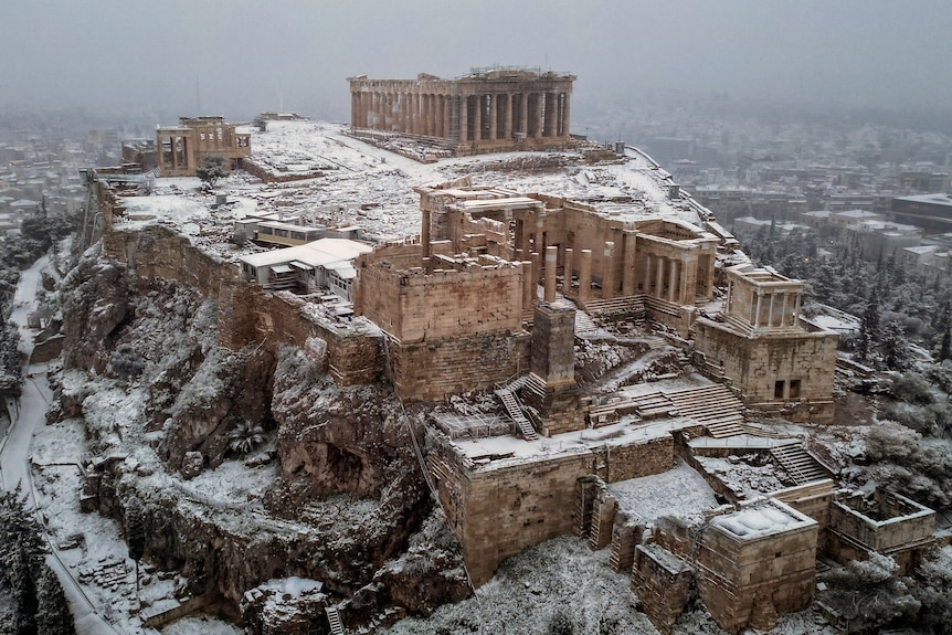 Acropolis hill in Athens is dusted in snow.