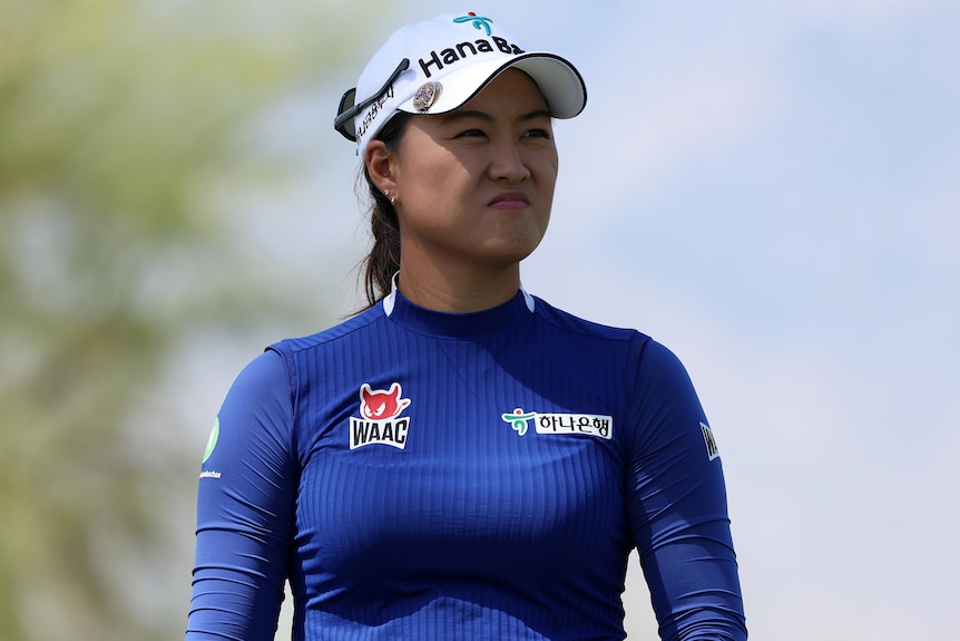 A professional Australian female golfer watches a tee shot in California.