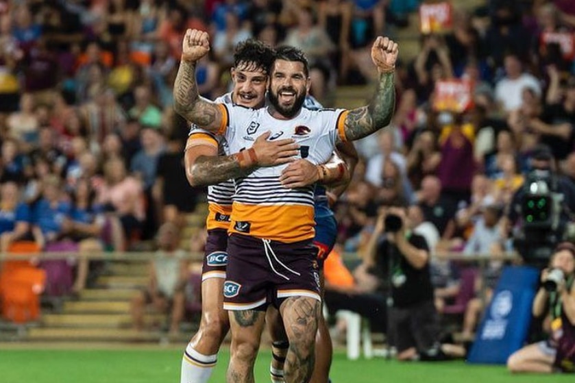 Two football players celebrate on the field