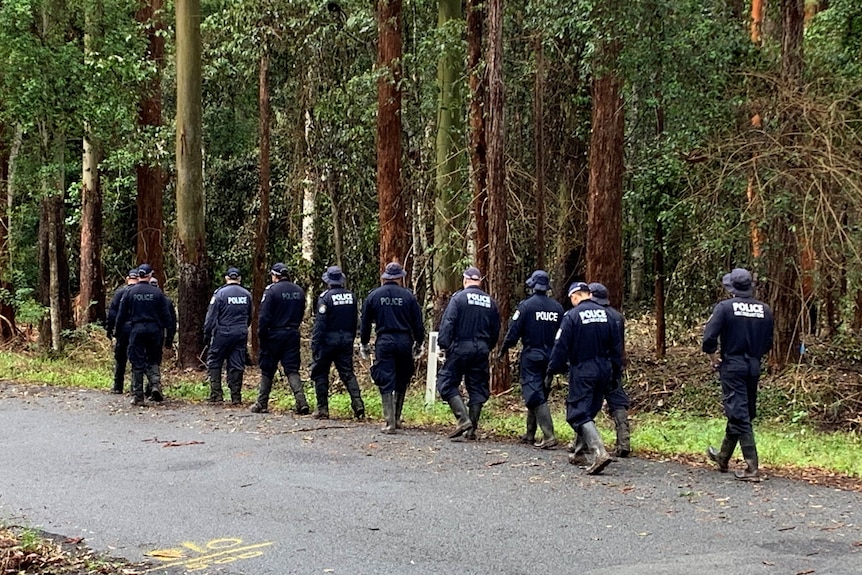 a group of police walking on a road