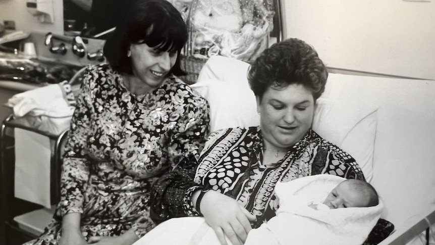 Two women in hospital with a baby.