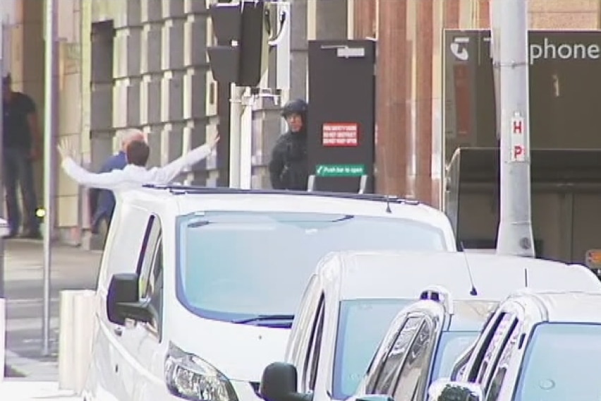 Two people walk out of building in Martin Place