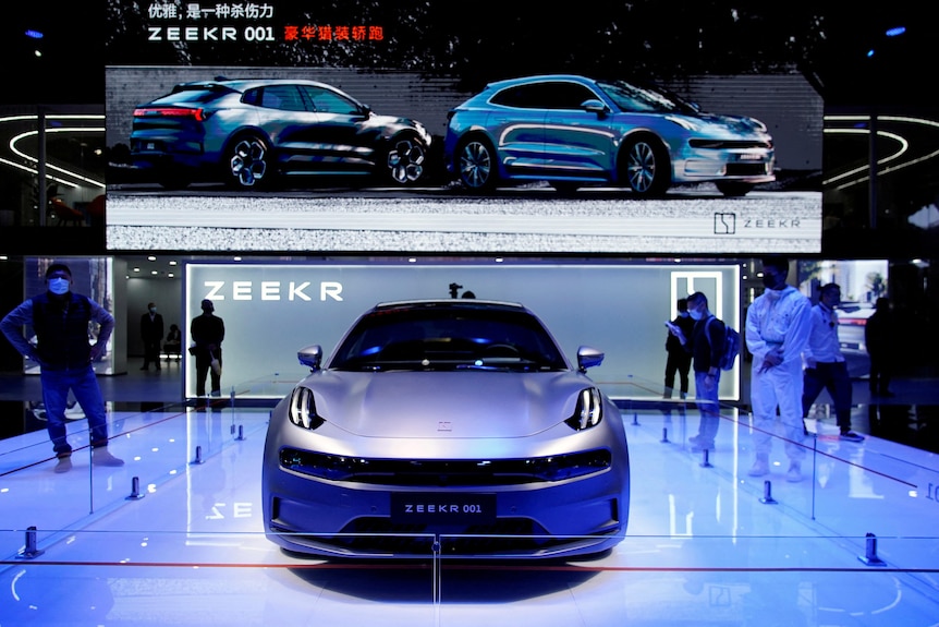 An electric vehicle by Geely is seen displayed at a car showroom.