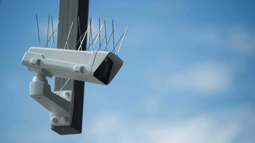 A security camera with spikes on it.