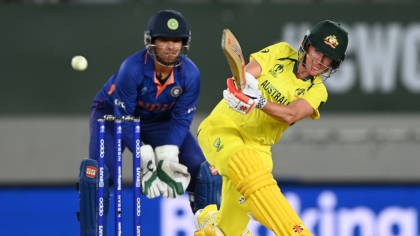 An Australian batter hits the ball through mid-wicket on the leg side during a Women's Cricket World Cup match.