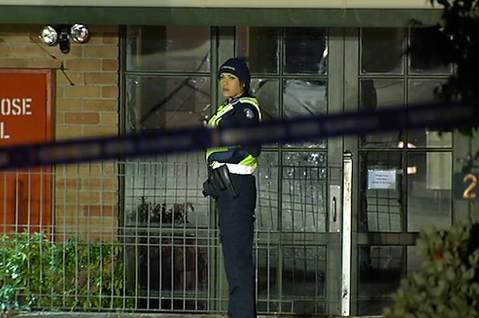 A policewoman stands guard at the crime scene.