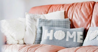 'Home' cushion on the sofa