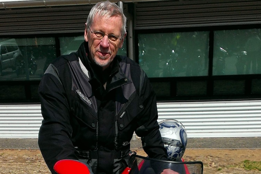 A man with a motorbike