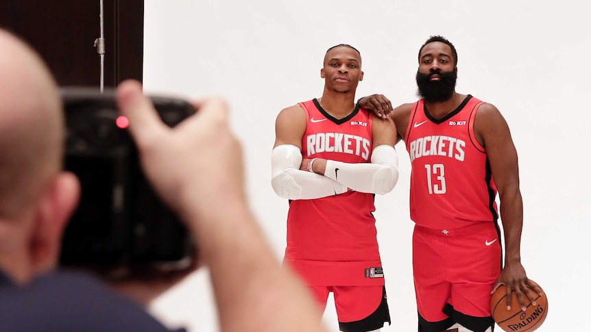 Two basketball players pose for a photograph