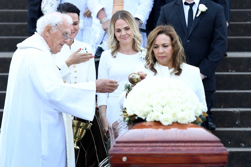 Les Murray's partner blesses the casket