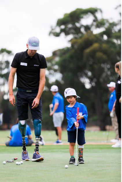 Mike Rolls playing golf with a child