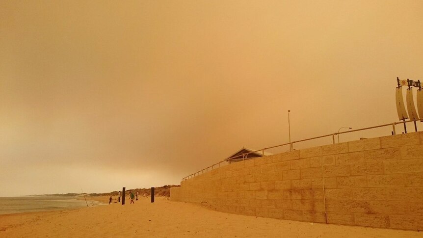 A giant yellow fire haze from the Waroona blaze viewed from Binningup Beach.