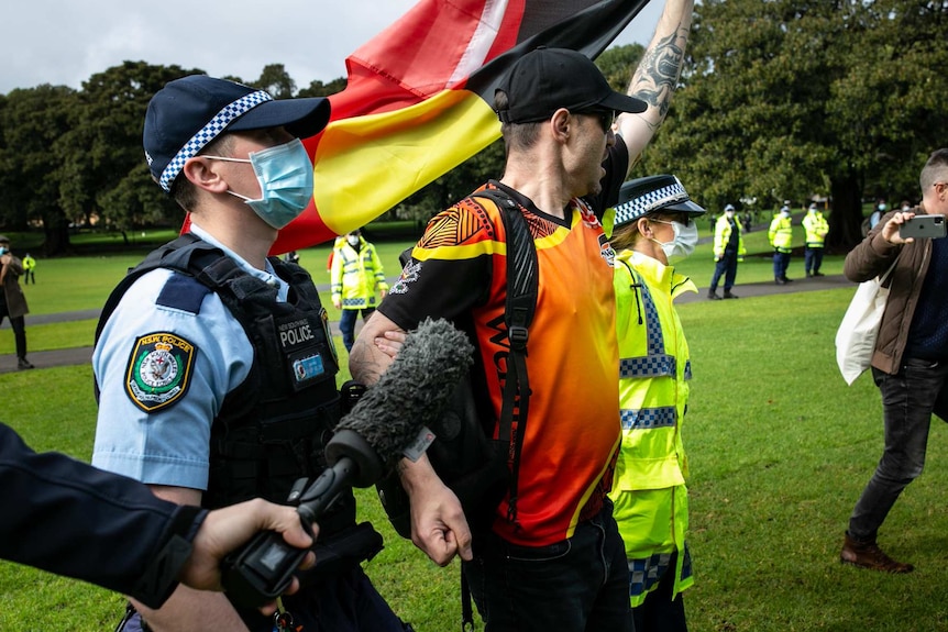 Police lead away a man