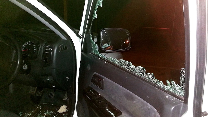 Car window smashed by rock