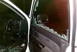 Car window smashed by rock