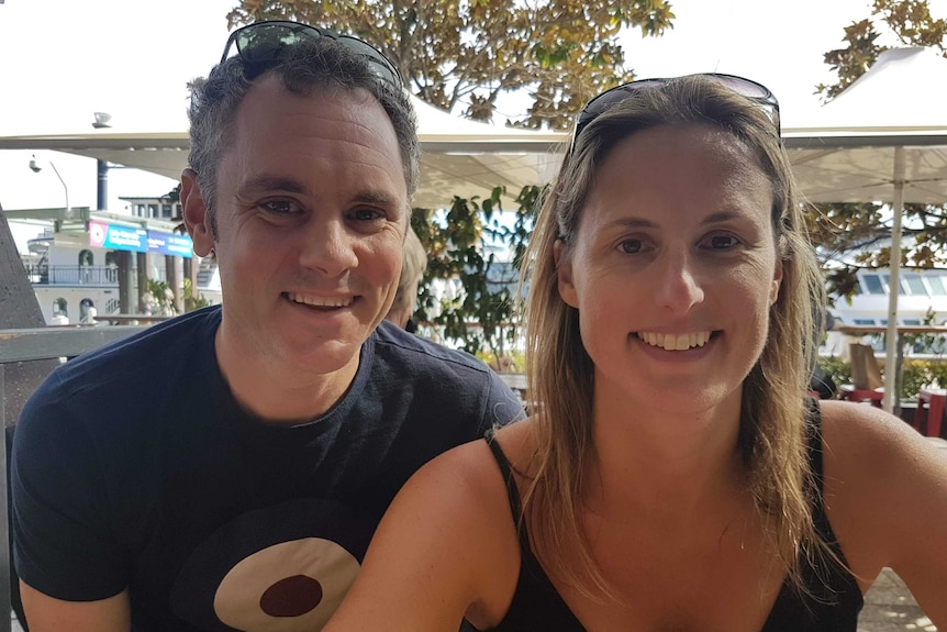 Angela Young and her partner Gary Cox sit at a table