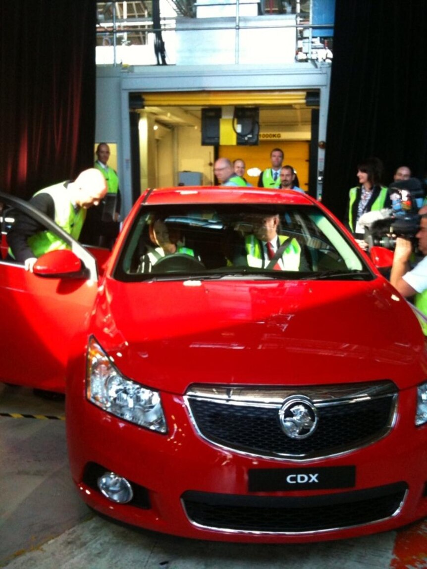 Julia Gillard sits behind the wheel of a Holden Cruze which has rolled off the production line at Elizabeth