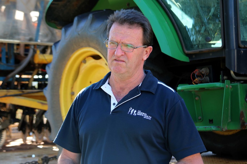 Owen Catto standing in front of some large machinery.