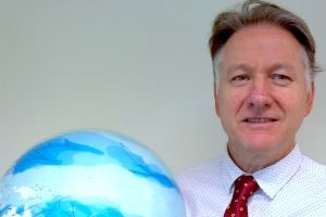Scott Power holding a globe