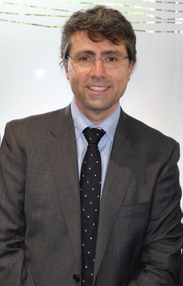 A man smiling in a suit