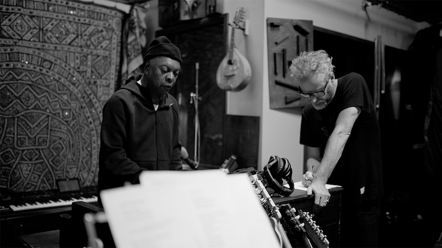 A candid black and white photo of Matt Berninger and Booker T in a recording studio together