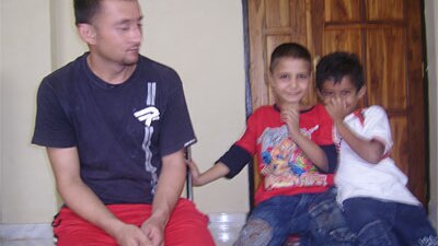 Norooz Ali and Mounir at the detention centre with Devan, the son of one of the guards (in white t-shirt)