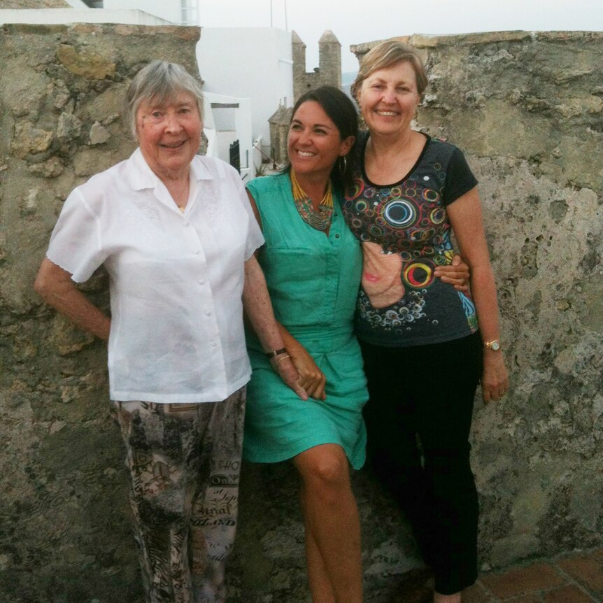 Three women of various ages stand together