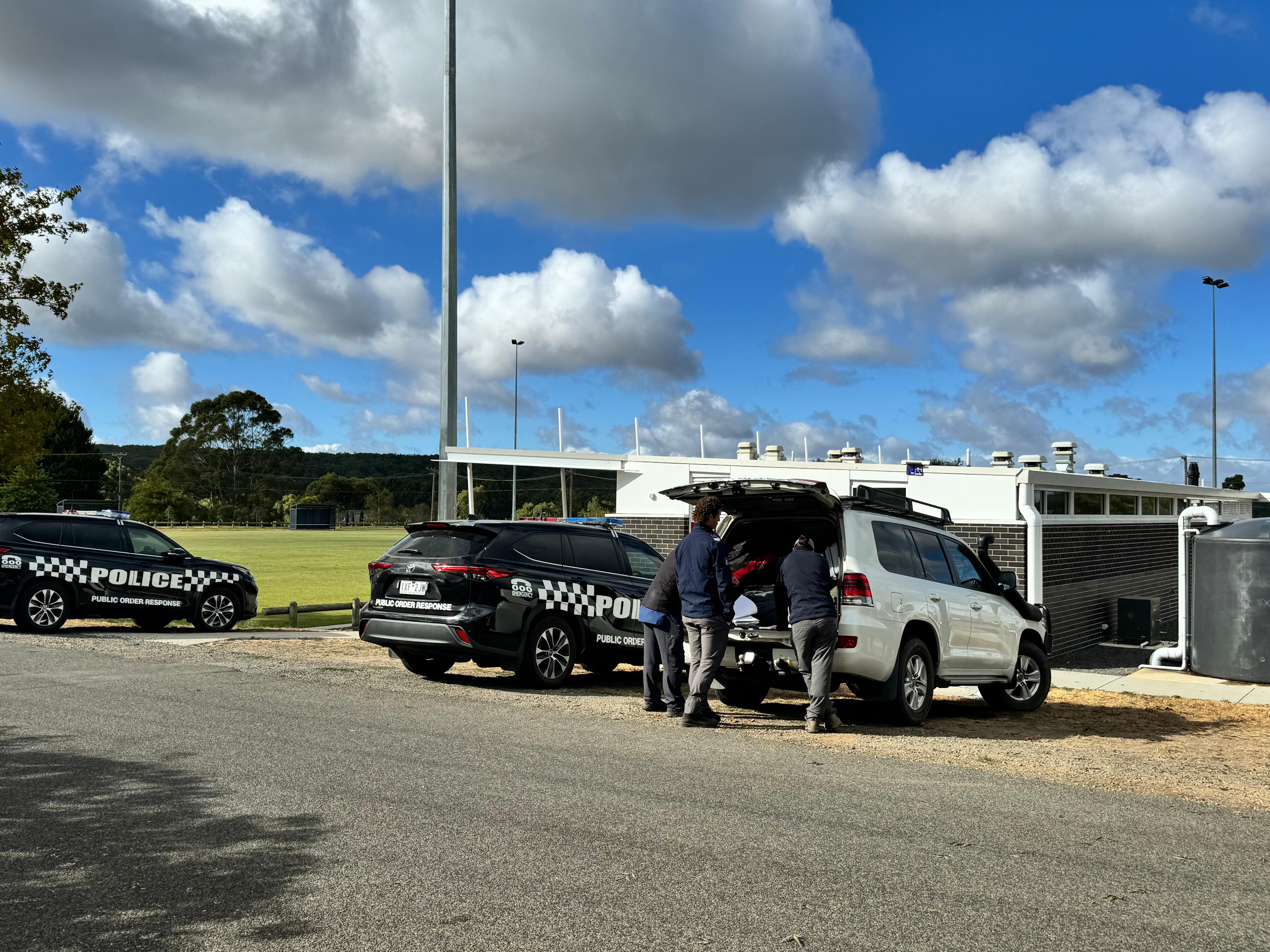 Police vehicles at an oval.