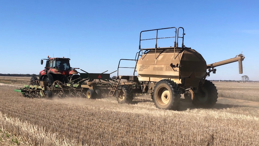 A tractor in a paddock.