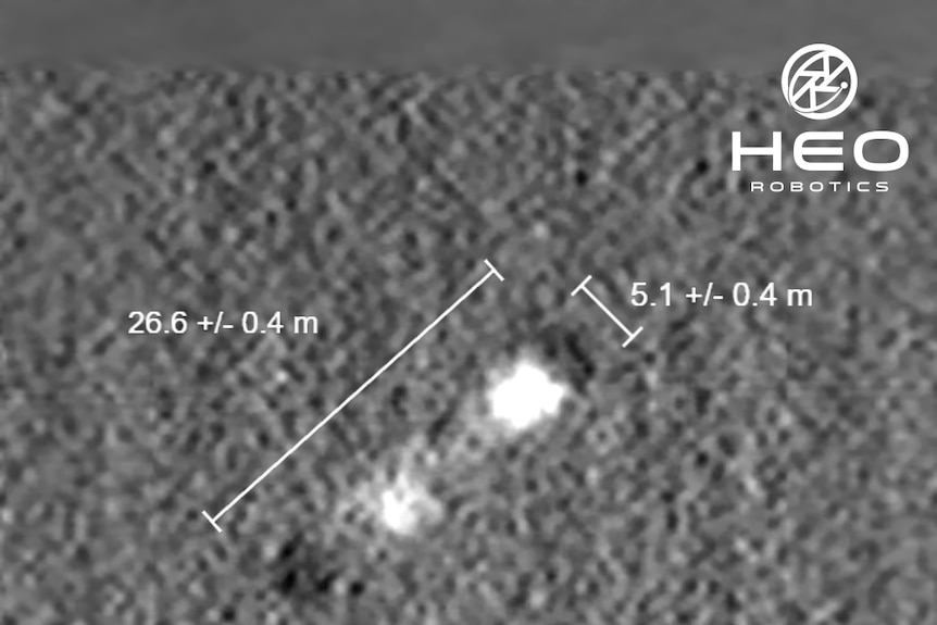 A grainy satellite image of a rocket stage in space, during its descent to Earth.