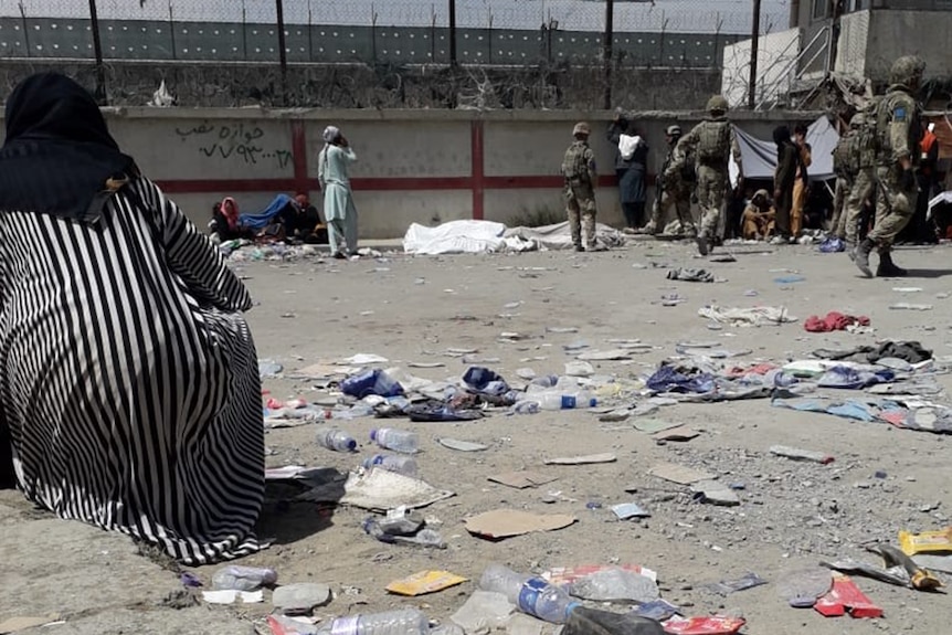 The scenes at Baron Camp during the exodus of Kabul - a bodie can be seen draped in cloth.