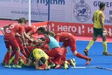 Belgian players celebrate a goal against Australia at the 2014 Champions Trophy in India.