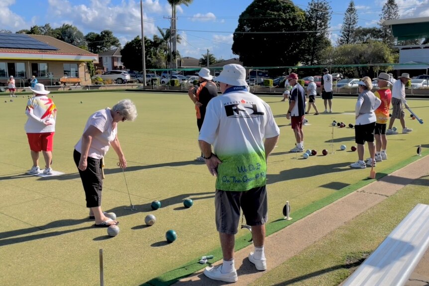 A group of people playing lawn bowls 