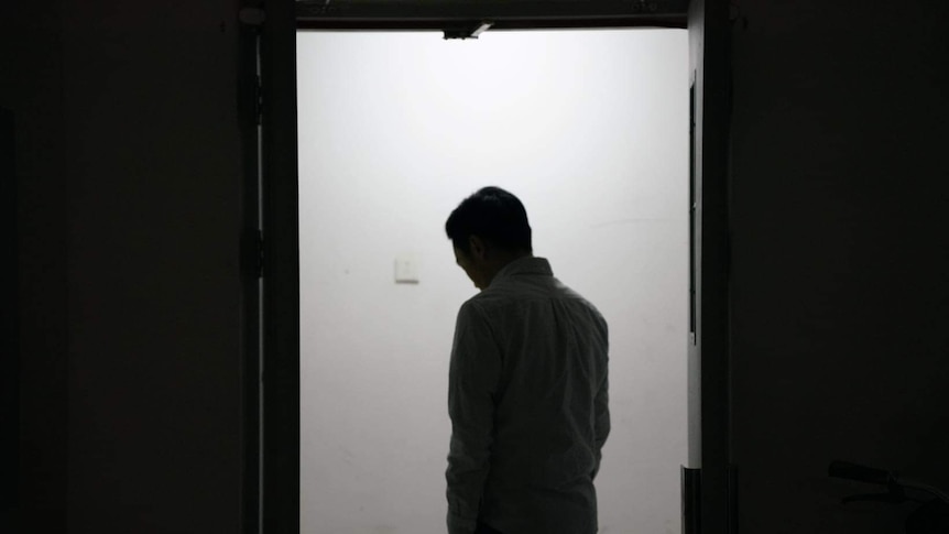 A silhouette of a man in a doorway. 