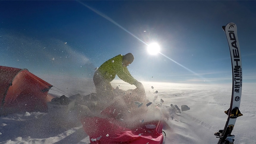 A storm sprays ice over the camp site of Greenland crossing record attempt