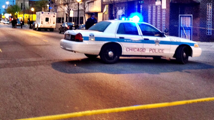 Police attend the scene of the fatal shooting in Chicago.