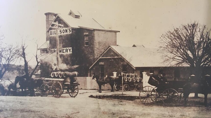 An old photo of Billson's Brewery with horse and carts out the front