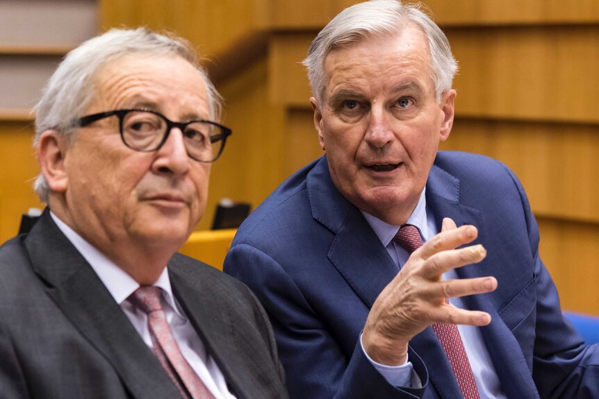 EU Commission President Jean Claude Juncker, left, and European Union chief Brexit negotiator Michel Barnier talking